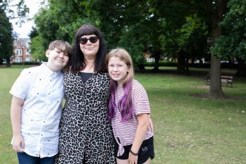 A mother with her son and daughter in a park